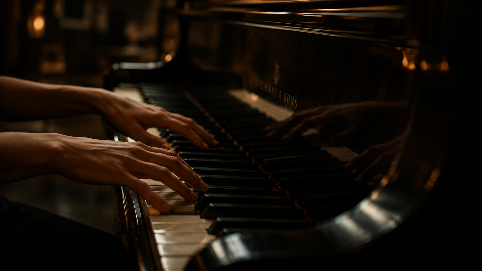 Close-up of hands playing a grand piano.